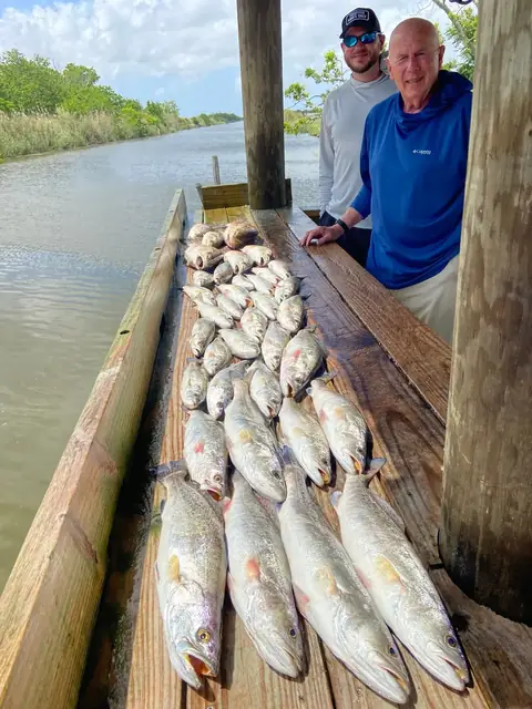 Two anglers beside their catch on the cleaning dock in Venice, Louisiana