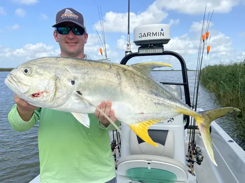 Angler holding a large jack crevalle on the boat near Venice, Louisiana