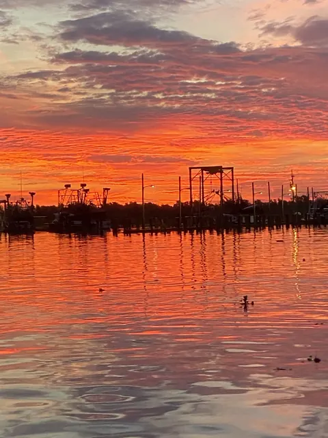A red sky reflected in the water at the marina in Venice, Louisiana