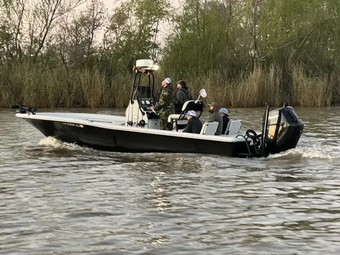 The Southern Delta Charters bay boat running along the cane with guests aboard