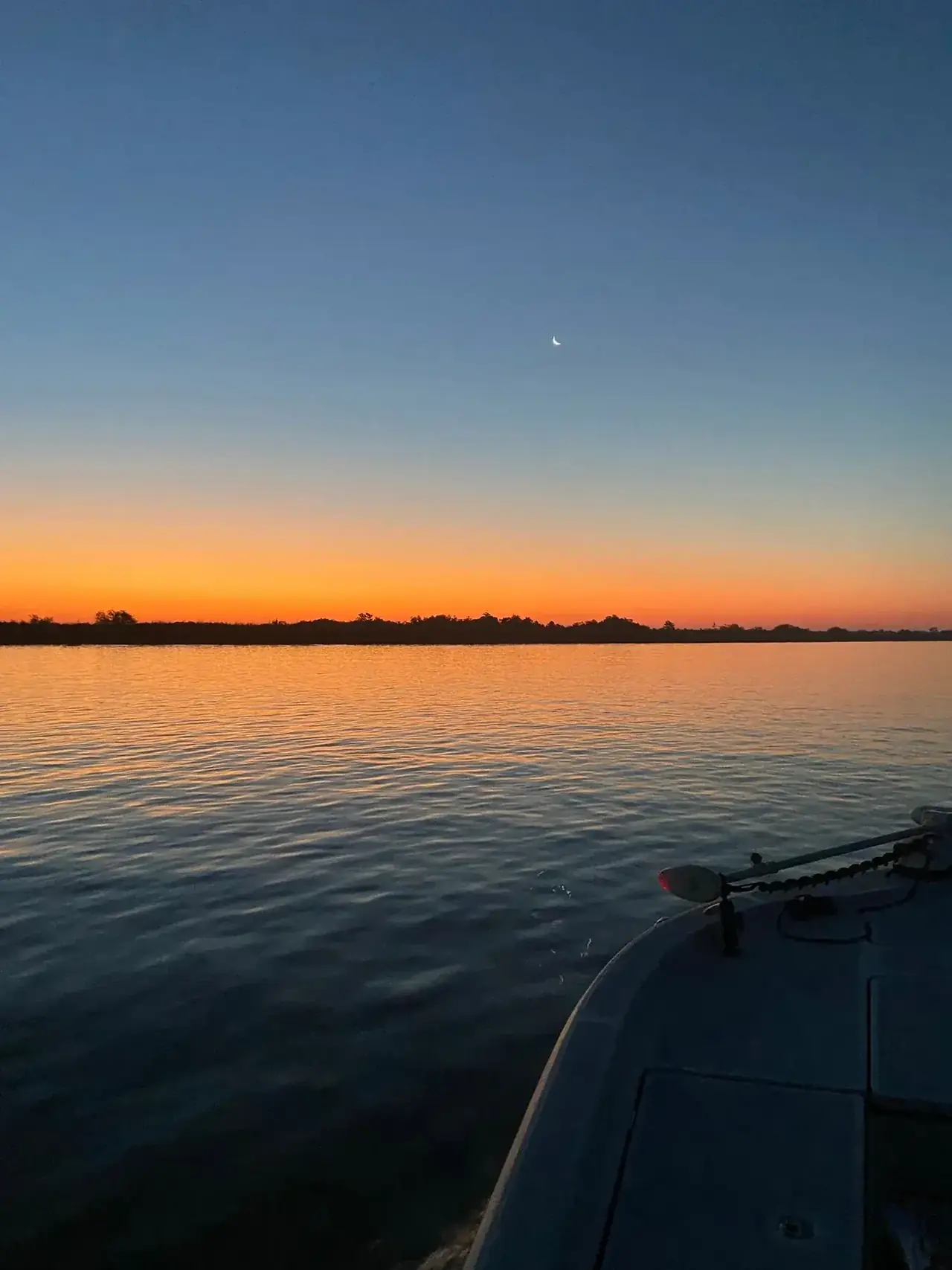 First light over the delta seen from the bow of the boat